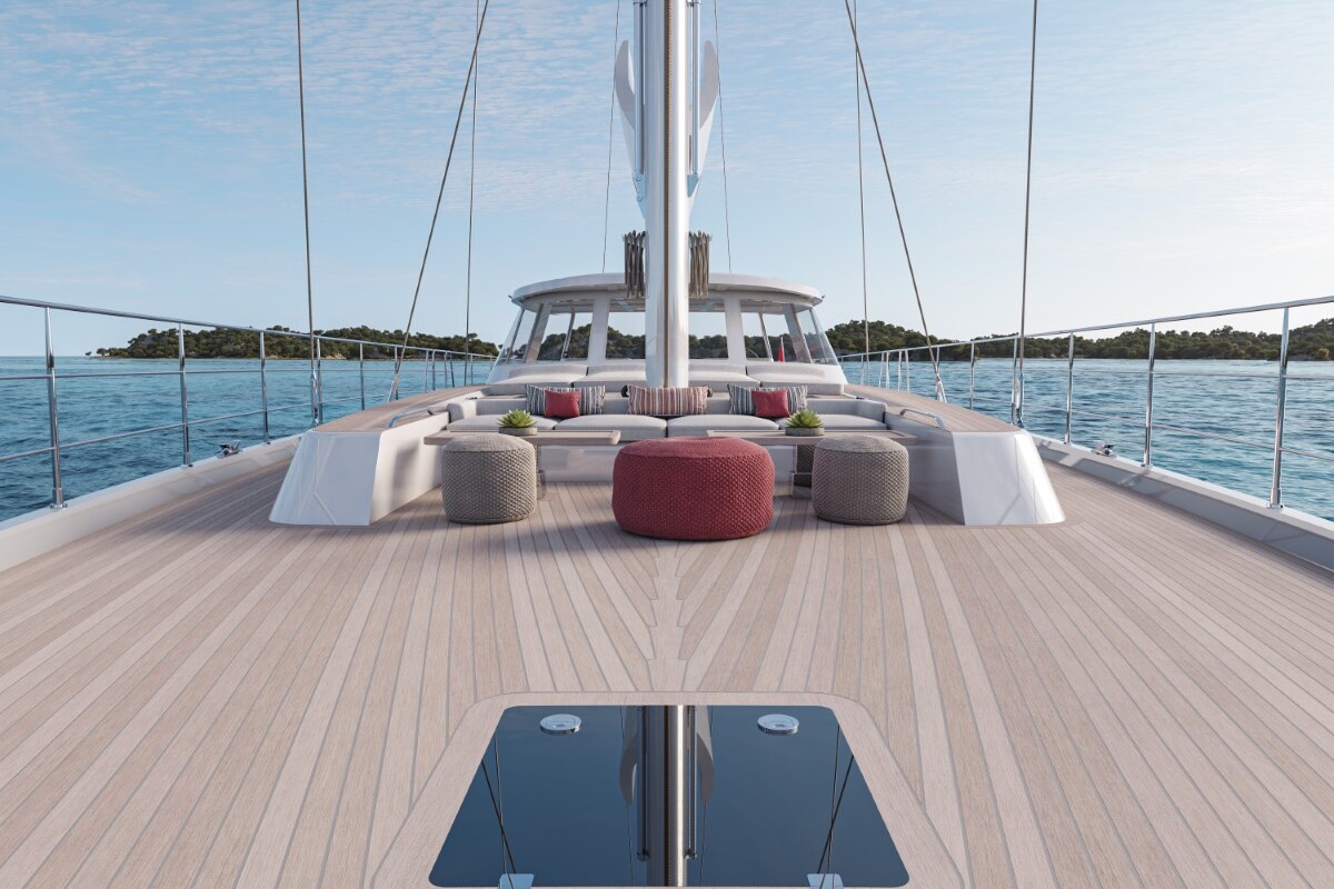 Meta Design Studio, Yacht Animation, 3D Animation, Yacht Rendering, 3D Rendering, Luxury Visualization, Yacht Visualization View from the deck of a yacht at sea, with wicker chairs and ottomans arranged around tables. The calm water and distant green islands are visible under a clear blue sky.