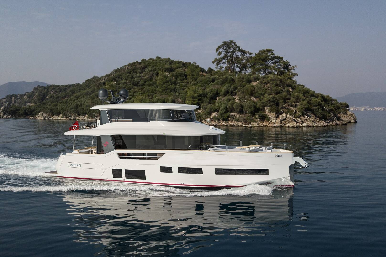 Meta Design Studio, Yacht Animation, 3D Animation, Yacht Rendering, 3D Rendering, Luxury Visualization, Yacht Visualization A modern white yacht cruises on calm, blue water near a lush, green island under a clear sky, with distant mountains visible in the background.